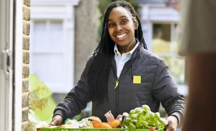 Female Waitrose delivery driver smiling