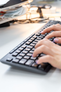 Hands typing on a keyboard