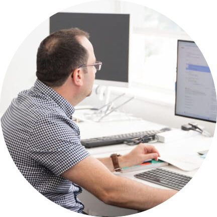 Enhance Media employee at his desk